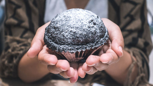 Close-up of hand holding ice cream