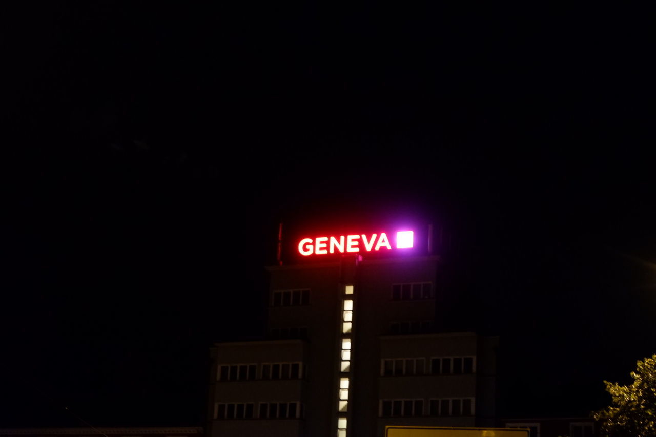 night, illuminated, architecture, light, text, building exterior, darkness, communication, western script, built structure, sign, lighting, no people, copy space, city, neon, evening, guidance, building, outdoors, low angle view, dark, nature, sky