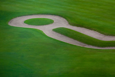 High angle view of arrow symbol on grass