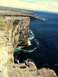 High angle view of rock formation in sea against sky