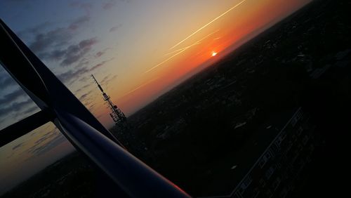 Silhouette airplane against sky during sunset