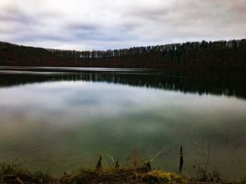 Scenic view of lake in forest against sky