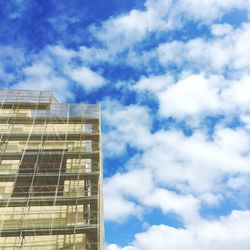 Low angle view of building against cloudy sky