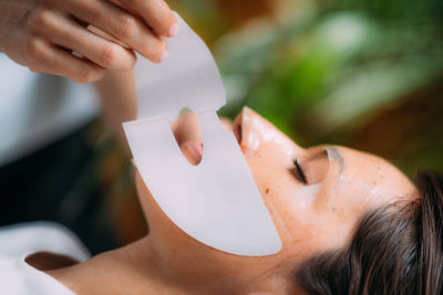 Woman with skincare face mask in beauty salon