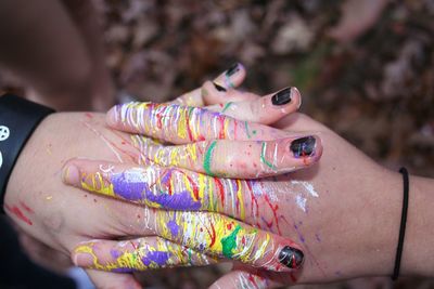 Cropped hands of women with paint