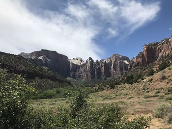 Scenic view of land and mountains against sky