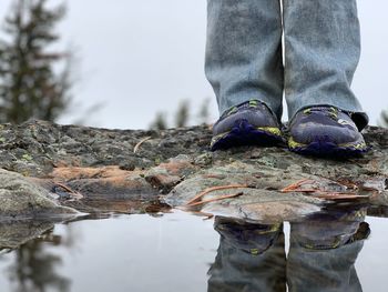 Low section of man standing on rock