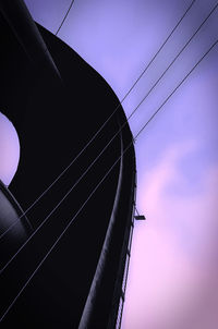 Low angle view of electricity pylon against sky