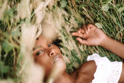 Young black woman relaxing in the grass