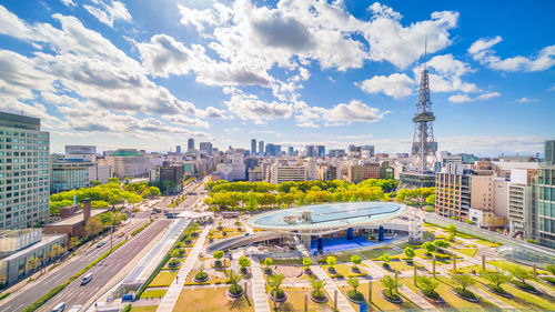 High angle view of city buildings against cloudy sky