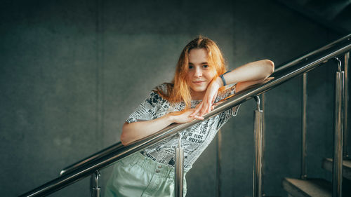 Portrait of young woman sitting on staircase