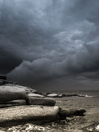 Scenic view of sea against storm clouds