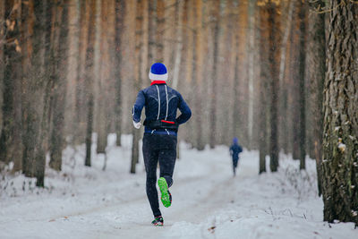 Full length of man skiing on snow covered field