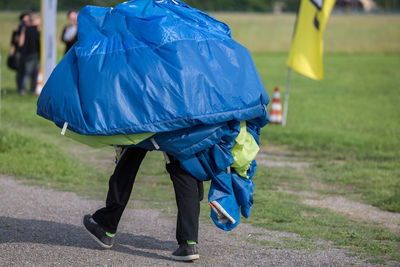 Rear view of man walking on road