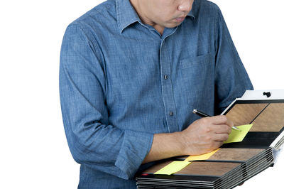 Midsection of man using mobile phone