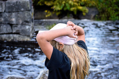 Rear view of woman standing in water