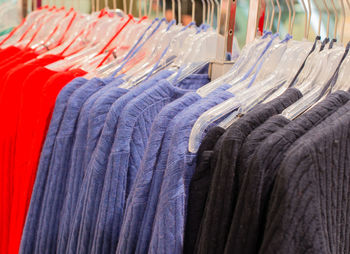 Close-up of clothes hanging on rack at store