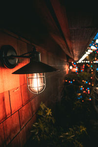 Low angle view of illuminated lanterns hanging on wall