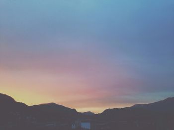 Scenic view of mountains against sky at sunset