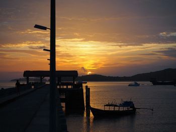 Silhouette pier on sea against sky during sunset