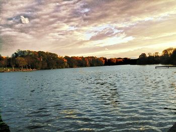 Scenic view of lake against sky at sunset