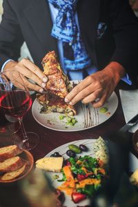 Midsection of man preparing food on table