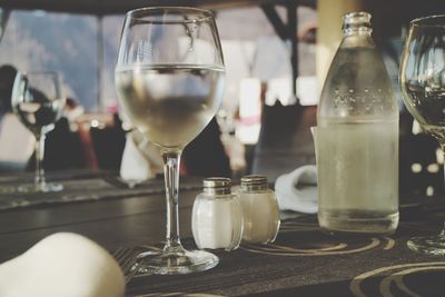 Close-up of wine glasses on table