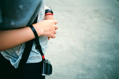 Cropped image of woman holding camera