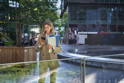 Portrait of young woman using mobile phone