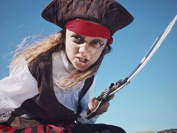 Portrait of girl wearing pirate costume against sky