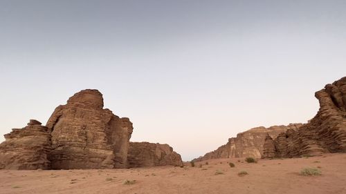 Rock formations on landscape against clear sky