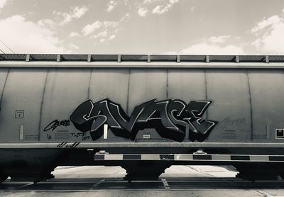 Graffiti on bridge against sky