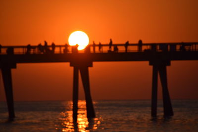 Scenic view of sea against orange sky during sunset