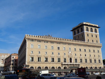 Buildings in city against blue sky