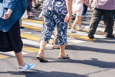 Low section of people walking on road