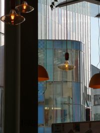 Low angle view of illuminated pendant lights in building