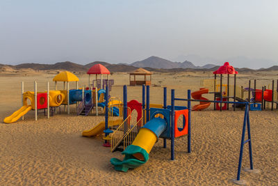 Multi colored chairs on beach against sky a park in the desert.