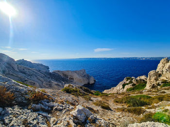 Scenic view of sea against clear blue sky