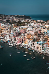 High angle view of townscape by sea against sky