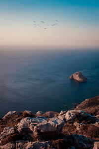 Scenic view of sea against sky at sunset