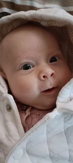 Portrait of cute baby girl sleeping on bed