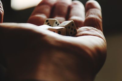 Close-up of hand holding dices
