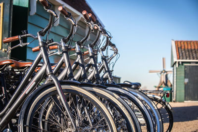 Bicycles on street in city against sky