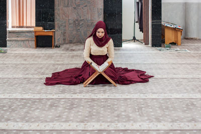 Portrait of young woman sitting outdoors