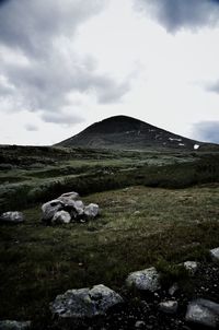 Scenic view of mountains against cloudy sky