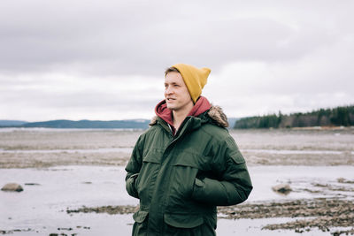 Portrait of a man smiling whilst standing alone in the great outdoors