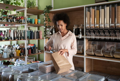 Black small business owner packing organic pasta