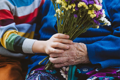 Midsection of couple holding hands