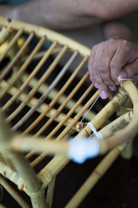 Close-up of man making wooden chair