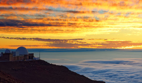 Scenic view of sea against orange sky